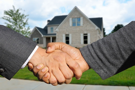 A property buying agent and selling agent shaking hands